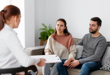 a woman in a wheelchair is being interviewed by a man in a wheelchair