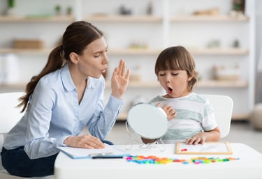 a woman sitting at a table with a child