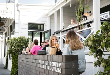 Two female guests are dining on a restaurant terrace