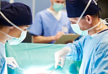 A surgical team performing an organ transplant procedure in a sterile operating theater.