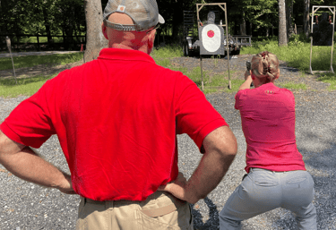DT trainer on the shooting range with female student.