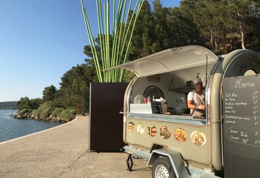 a food truck with a man standing in front of it
