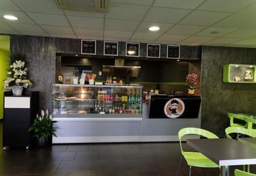 a restaurant with a counter top and a table with chairs
