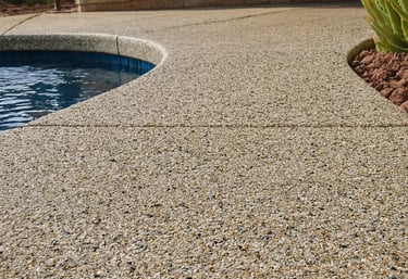 a pool with exposed aggregate concrete deck