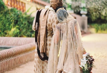 a bride and groom walking down a path