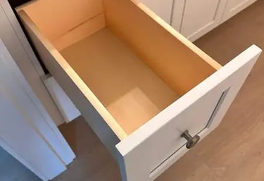 Open box inside a white shaker cabinet, showing solid wood construction and smooth finish.