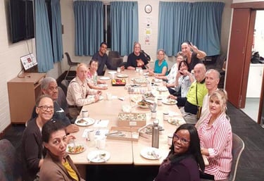 a group of people sitting around a table sharing meals