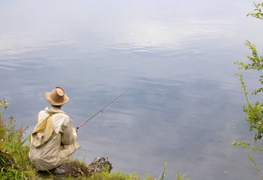 Fisherman sitting on shore