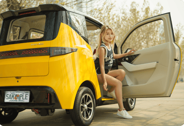 woman getting out of yellow Impulse Electromotive Nano-3 Micro EV car