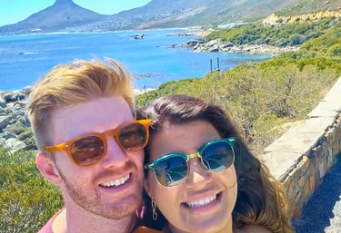a man and woman taking a selfie with a mountain in the background