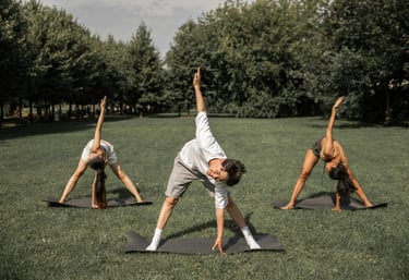 a small group of people doing exercise in a park