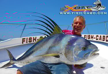 a man holding a fish on a boat