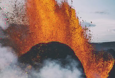 a group of people standing around a volcano