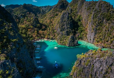 a boat in the water near a mountain  El Nido Palawan