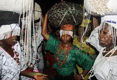 A woman in a green dress with a large basket on her head