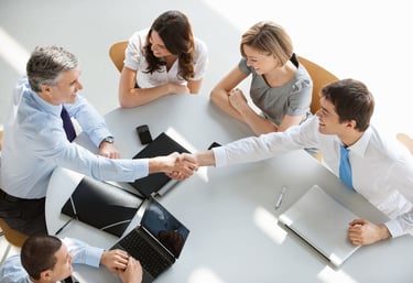a group of business people shaking hands