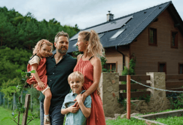 a family of three children standing in front of a house with solar energy system