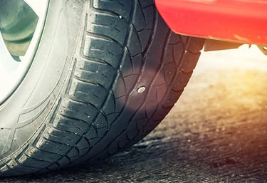 a close up of a punctured tyre on a car