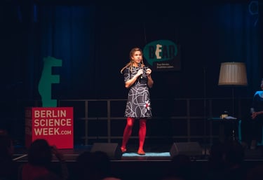 Female scientist on stage telling a story