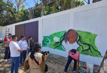 Ministery of Culture gathering during a colorful street art mural of a jaguar and figure is painted.