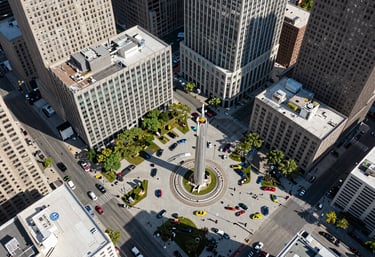 An aerial view of a vibrant, modern city square in the United States, representing the fast-paced and interconnected nature of modern business.