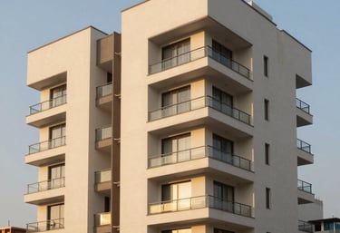 Architectural photography of a luxury residential building in Miraflores, Lima, Peru. Modern clean lines, ivory facade, warm sunset lighting, high contrast.
