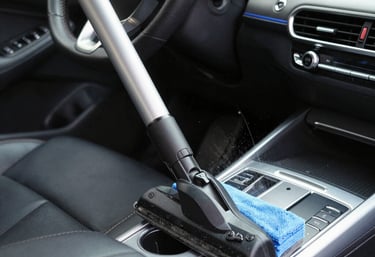 Happy customers receiving keys from a Go Drive Auto Rental agent beside a lineup of available rental cars.