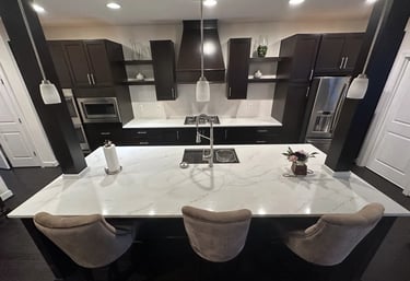 Overhead view of kitchen island featuring new quartz countertops with brown veins.