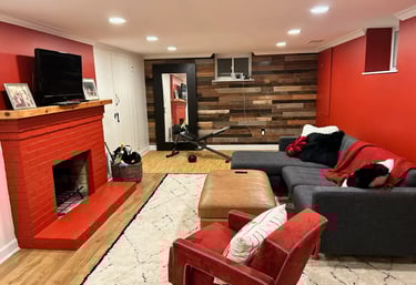 renovated basement with red wall, reclaimed wood accent wall.
