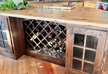 Rustic kitchen island featuring a built-in wooden lattice wine rack and butcher block countertop.