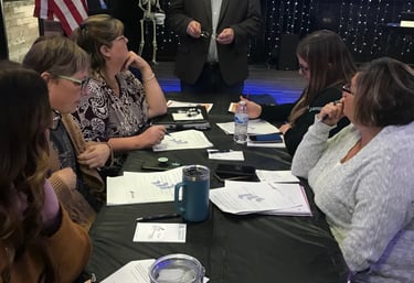 a group of people sitting around a table
