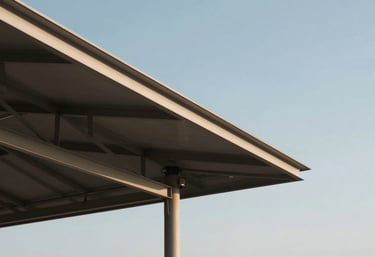 An artistic exterior shot of a pavilion's roof line against a clear sky, showing the geometric beauty and clean lines of the steel engineering work.