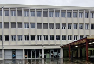 a building with a bunch of windows and a bench in front of it