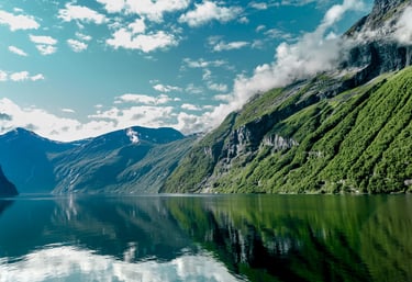 a mountain scene with a lake and mountains in the background