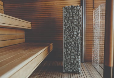 Cedar sauna interior with Scandinavian heater and benches in an Outdoor sauna Ontario design