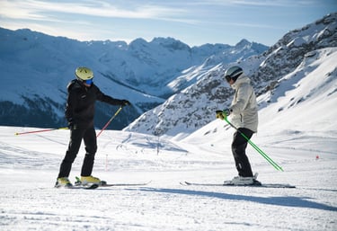 Private ski instructor teaching an adult skier in Crans-Montana