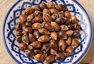 Close-up of fresh argan nuts and vibrant Moroccan flowers on rustic wooden table.