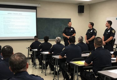 Close-up of hands reviewing detailed police department strategy documents.