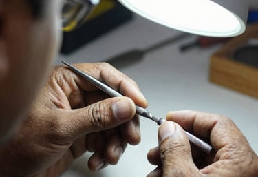A close-up shot of a skilled Pakistani craftsman's hands using a fine micro-file on a surgical instrument under a bright lamp. The workshop is clean and orderly, emphasizing the artisanal precision in the production process.