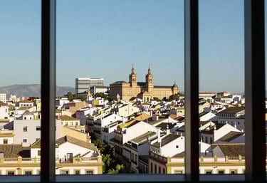 A visionary view of a Spanish / Iberian city skyline from a modern office window, symbolizing ambition and motivation.