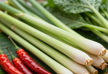 A vibrant assortment of Thai vegetables like bright green lemongrass stalks and red bird's eye chillies, shot in a high-contrast style that utilizes the #1E3A2F brand color in the shadows.