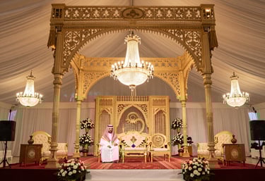 A joyful Saudi family celebrating a wedding with traditional decorations.