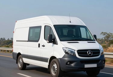 Photography of a clean medium-blue and white delivery van driving on a modern Indian highway under a clear blue sky, sleek and professional look.