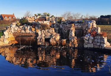 Custom corner water feature on a raised block ponds to bring the sound of running water