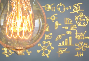 Glowing light bulb with business strategy icons representing innovation and creative planning.