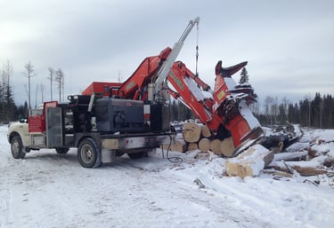 Service truck with picker working on feller buncher