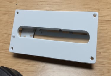 Finished 3D printed car parts arranged neatly on a workshop table.