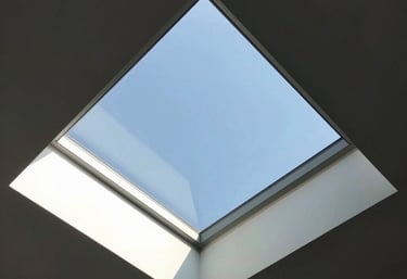Modern glass skylight window installed on a brown tiled residential rooftop for natural lighting.