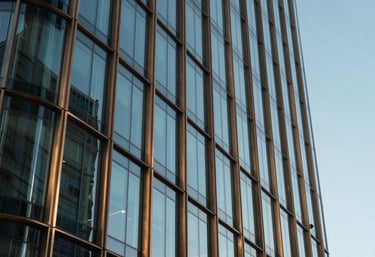A modern architectural detail of a Baghdad office building featuring glass and bronze frames, reflecting a clear blue sky, luxury corporate style.