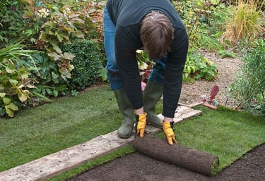 A Hedgie Wilder employee laying fresh turf in a garden in Markovo, Plovdiv.